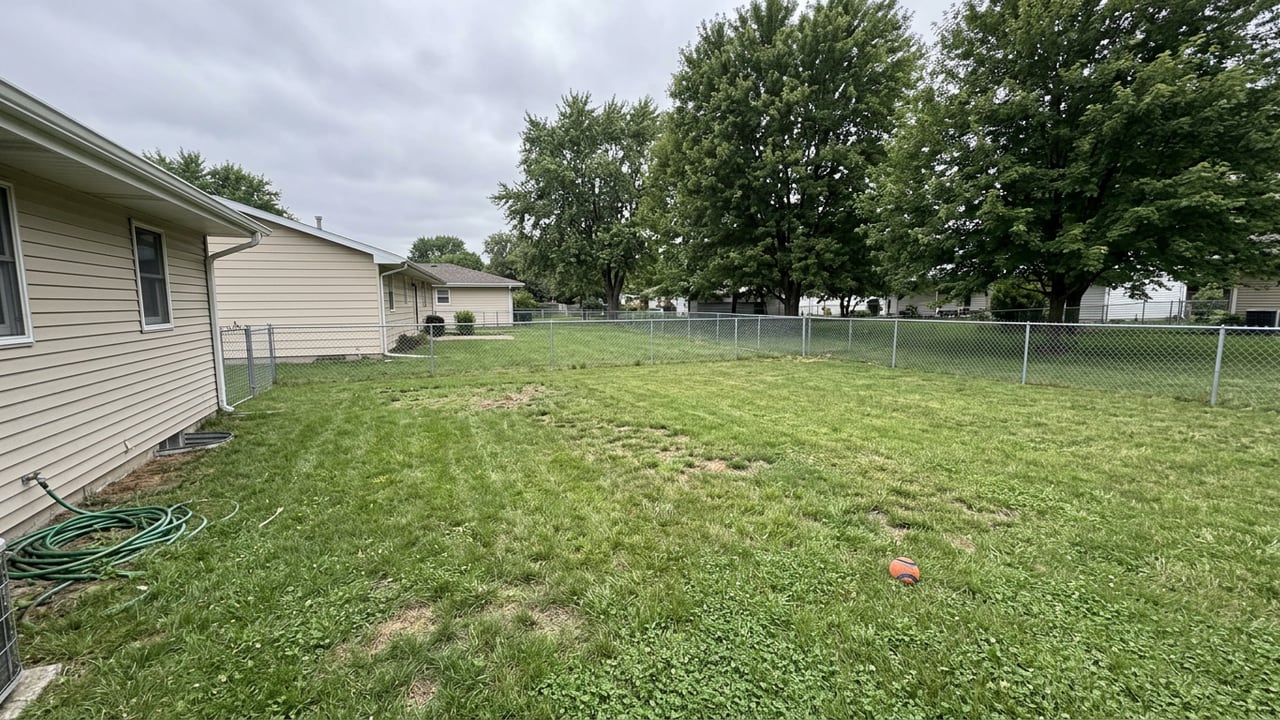 The same backyard completely clean and waste-free after a United Pooper Scoopers visit
